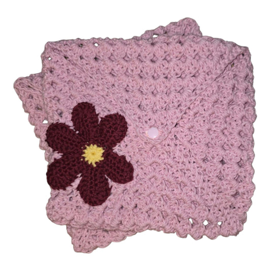 Pink crochet book sleeve with flower detail